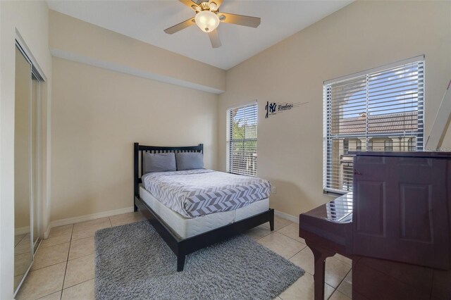 bedroom with ceiling fan, a closet, and light tile patterned flooring