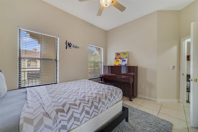 tiled bedroom featuring ceiling fan