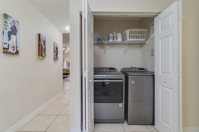 laundry area featuring washer and clothes dryer and light tile patterned flooring