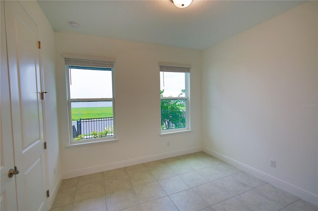 unfurnished room featuring a textured ceiling