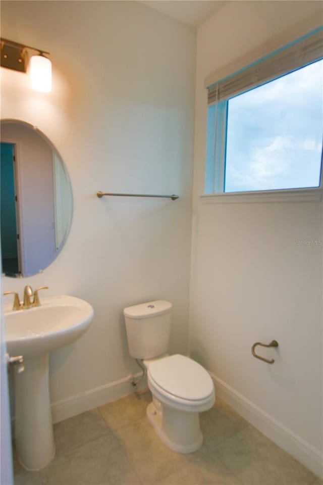 bathroom with sink, tile patterned floors, and toilet