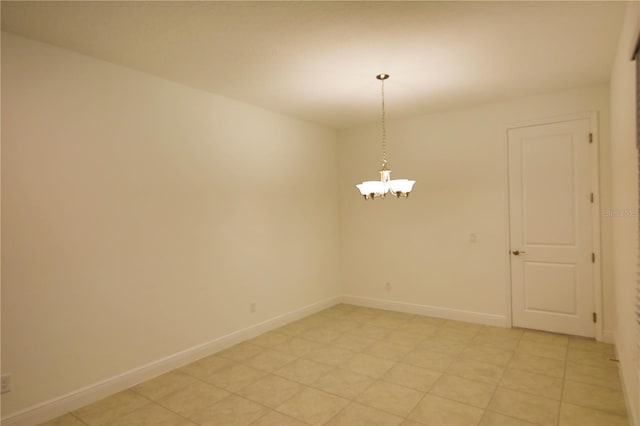 spare room featuring a notable chandelier