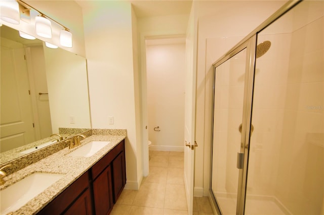 bathroom featuring vanity, tile patterned flooring, toilet, and walk in shower