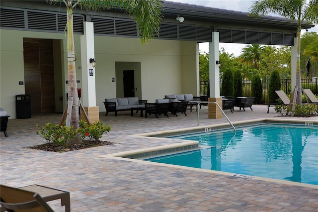 view of pool with outdoor lounge area and a patio