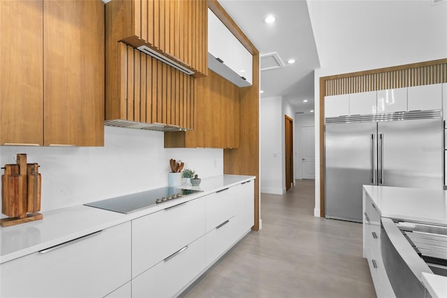 kitchen with white cabinetry, stainless steel built in fridge, black electric stovetop, ventilation hood, and stove