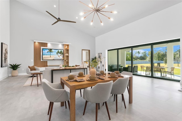 dining room featuring ceiling fan with notable chandelier and high vaulted ceiling