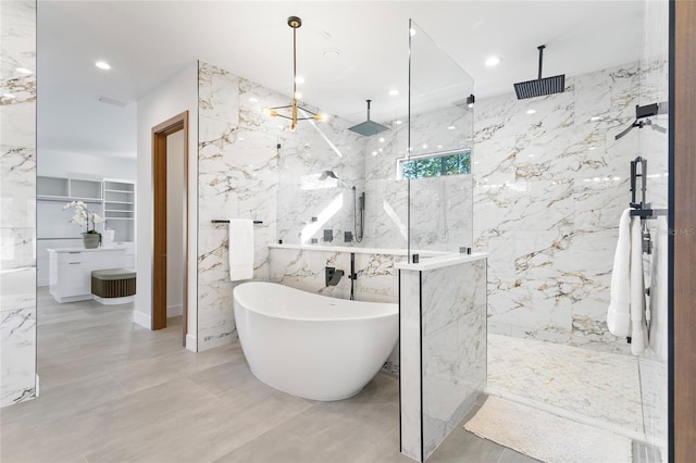 bathroom featuring a chandelier, tile walls, and separate shower and tub