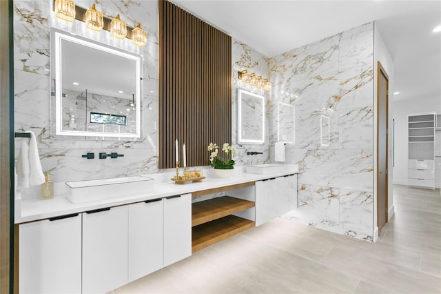 bathroom featuring a shower, tile walls, and vanity