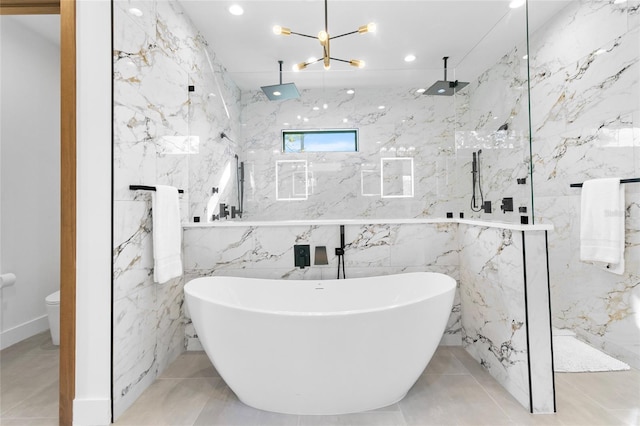 bathroom with tile walls, a chandelier, and shower with separate bathtub