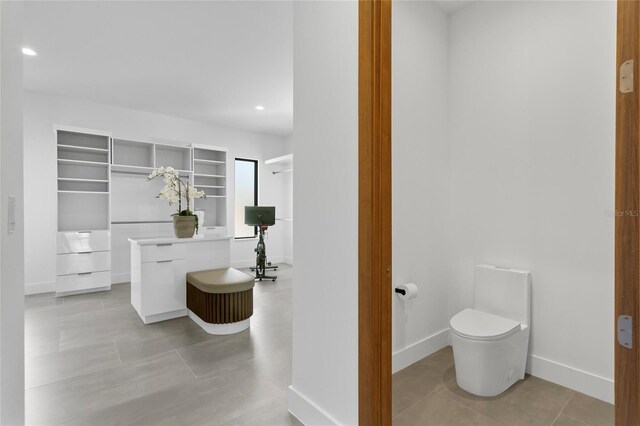 bathroom featuring toilet and tile patterned flooring