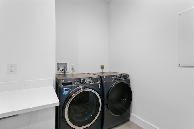 clothes washing area with washing machine and clothes dryer