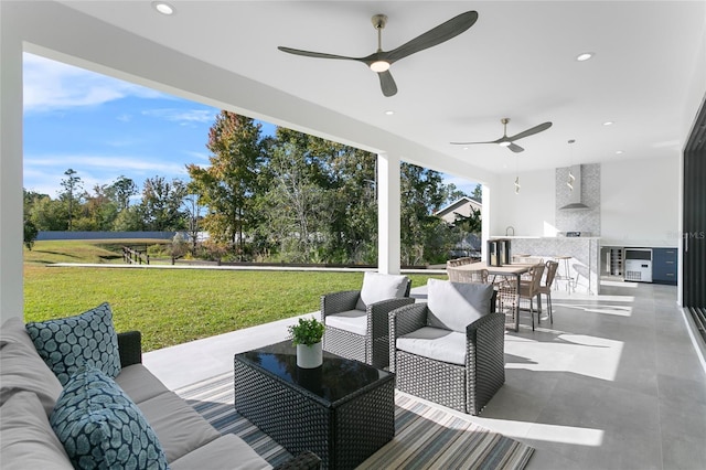 view of patio with ceiling fan, an outdoor living space, and exterior kitchen