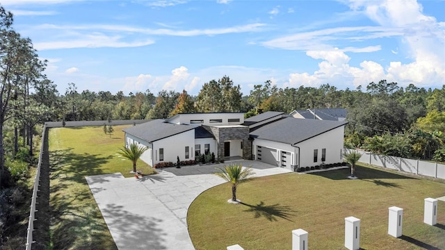 view of front facade featuring a front yard, a garage, and solar panels