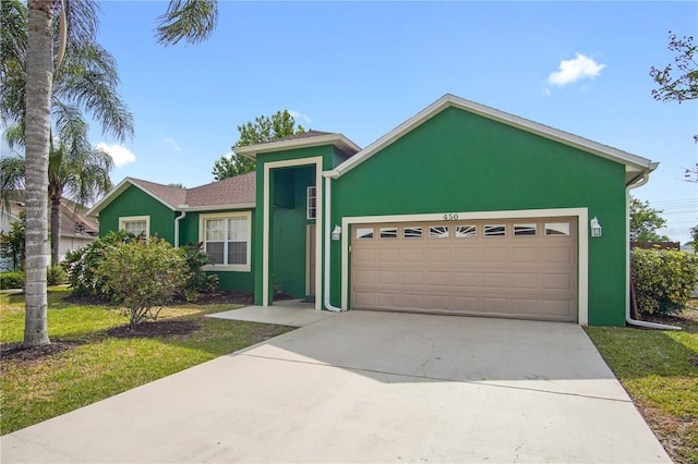 view of front of property with a front lawn and a garage