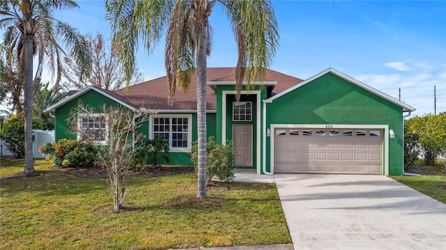 ranch-style house featuring a garage and a front lawn