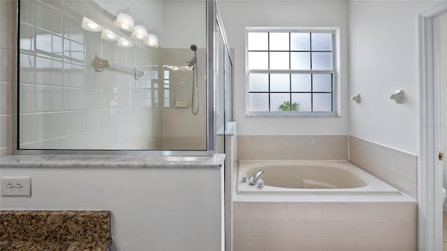 bathroom with shower with separate bathtub and toilet