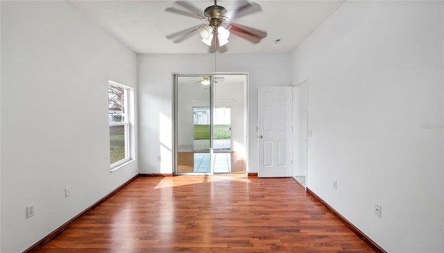 spare room with hardwood / wood-style floors and ceiling fan