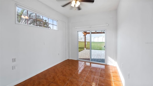 unfurnished room with tile patterned flooring and ceiling fan