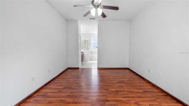 unfurnished room featuring ceiling fan and dark hardwood / wood-style floors