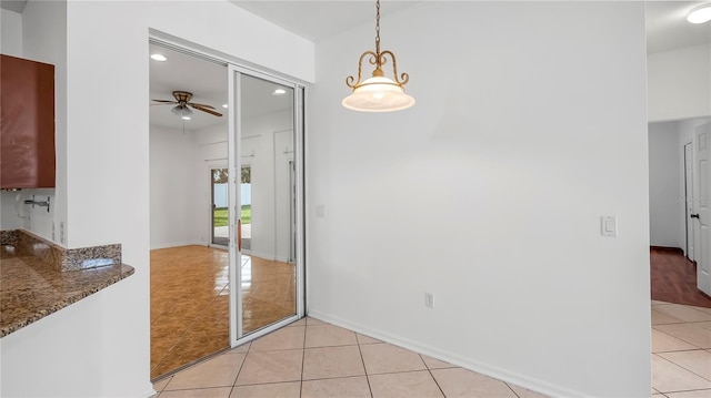 tiled dining area with ceiling fan