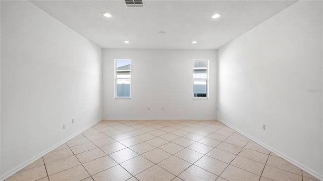 unfurnished room with light tile patterned flooring