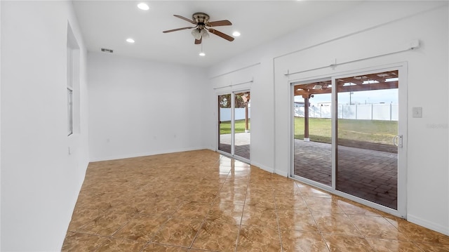 spare room with light tile patterned floors and ceiling fan