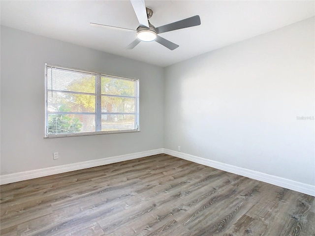 spare room with hardwood / wood-style floors and ceiling fan