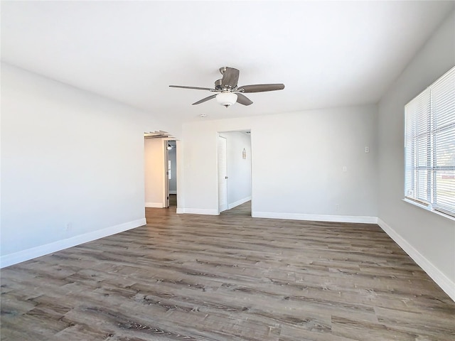 spare room with ceiling fan and dark hardwood / wood-style floors