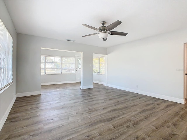 unfurnished room with dark wood-type flooring and ceiling fan