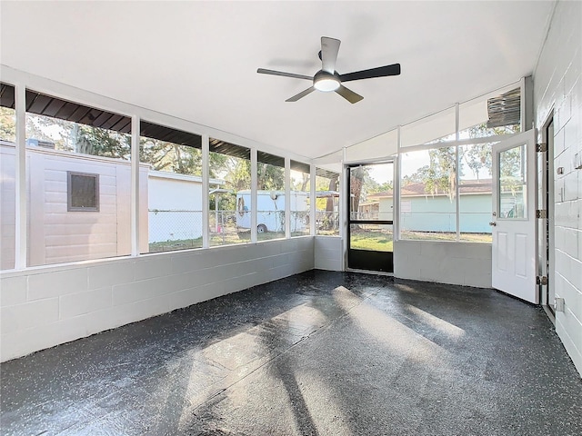 unfurnished sunroom featuring ceiling fan