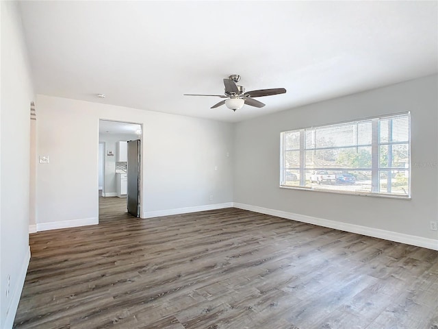 spare room with ceiling fan and dark hardwood / wood-style flooring