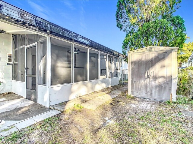 view of side of home with a storage shed