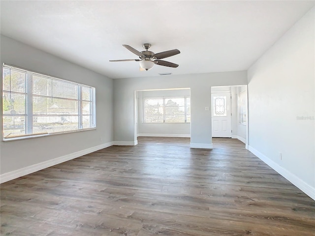 spare room with ceiling fan and dark hardwood / wood-style floors