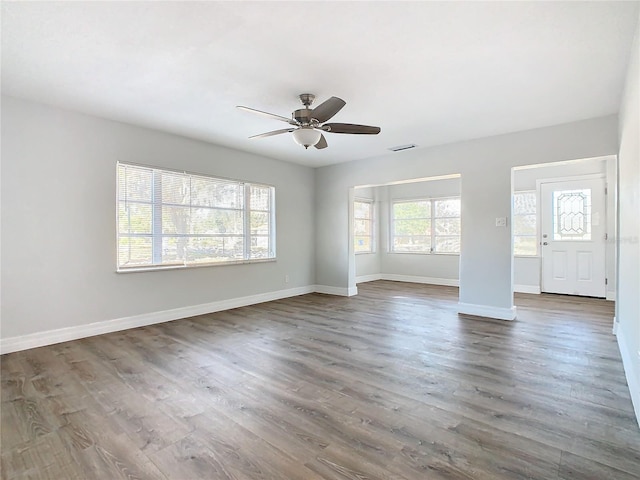 interior space featuring dark wood-type flooring and ceiling fan