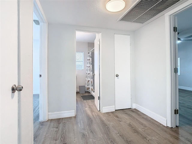 corridor with light wood-type flooring