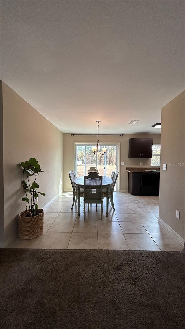 unfurnished dining area featuring light tile patterned floors