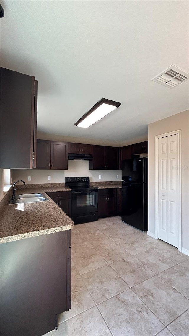 kitchen featuring dark brown cabinets, sink, light tile patterned floors, and black appliances