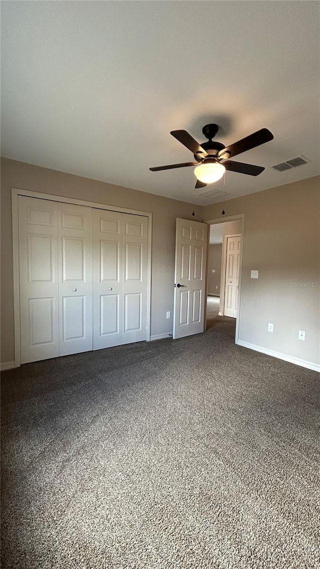 unfurnished bedroom featuring carpet flooring, ceiling fan, and a closet