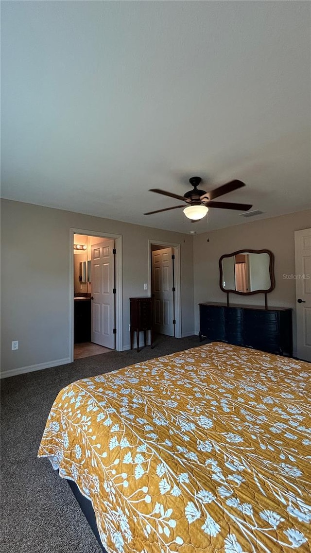 carpeted bedroom with connected bathroom and ceiling fan