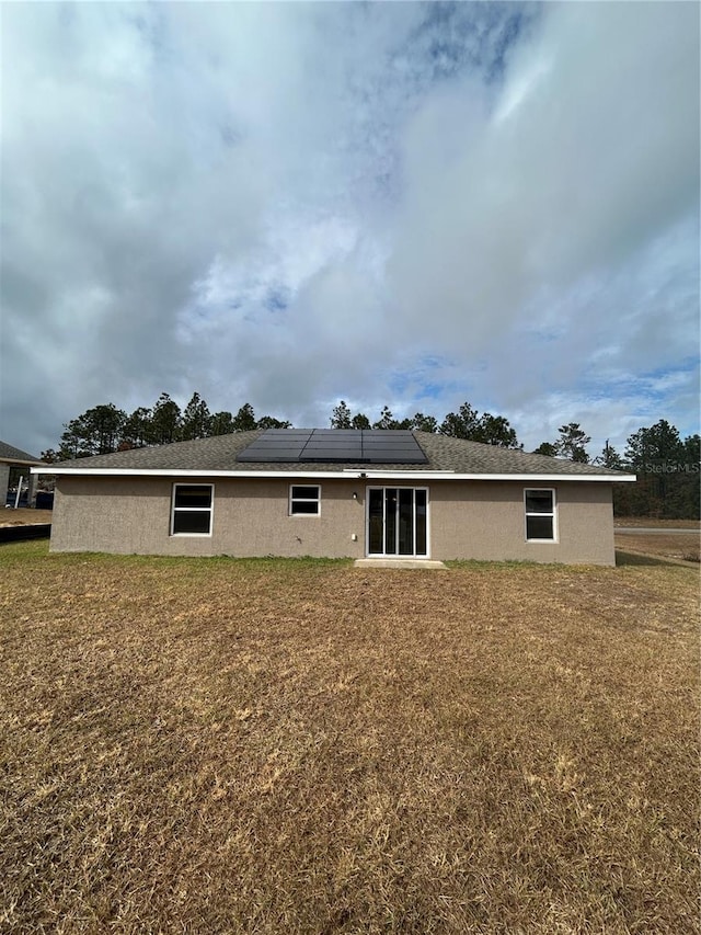 rear view of house with solar panels