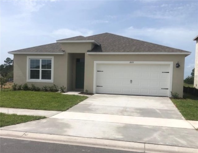 view of front of house with a garage and a front lawn