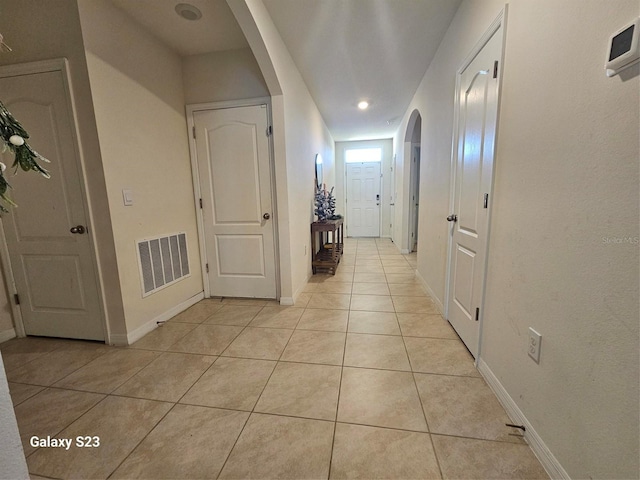 hall with light tile patterned floors