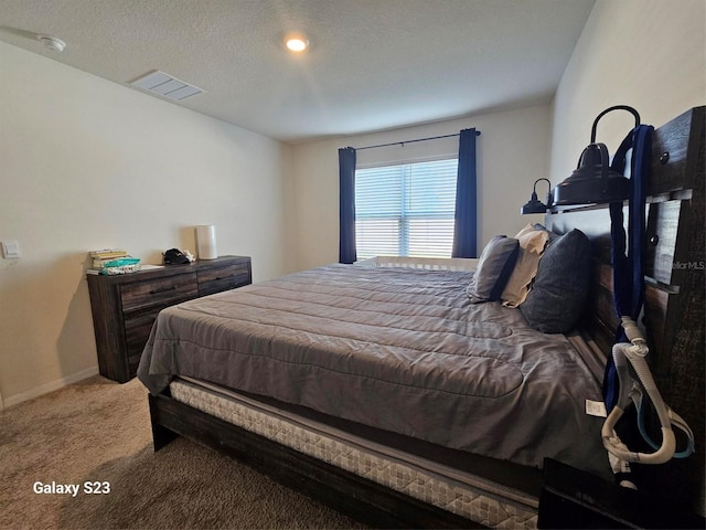 carpeted bedroom featuring a textured ceiling