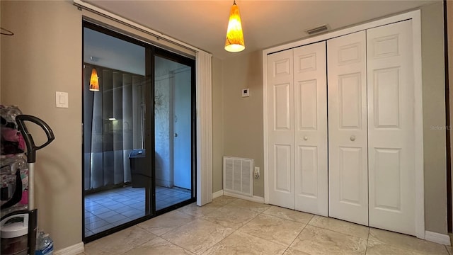 entryway with light tile patterned flooring