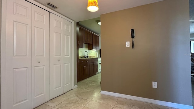 hall with light tile patterned floors