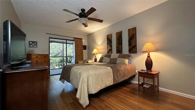 bedroom featuring access to exterior, ceiling fan, dark hardwood / wood-style flooring, and a textured ceiling