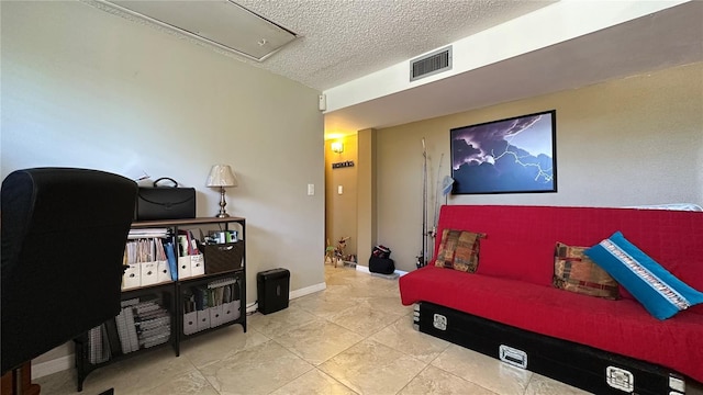 interior space with a textured ceiling and tile patterned floors