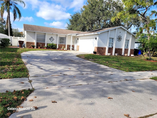 ranch-style house featuring a garage and a front lawn