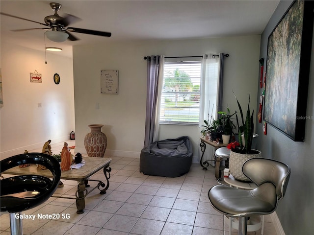 sitting room with ceiling fan and light tile patterned floors