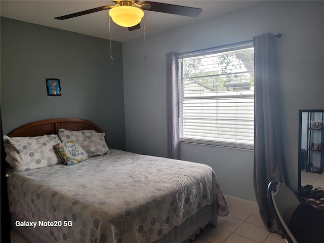 bedroom featuring light tile patterned floors and ceiling fan